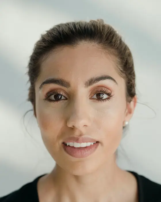 Anika Desai, Richmond leasing agent, smiling, with dark hair pulled back and a black top.