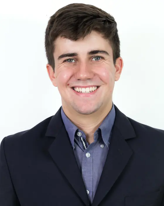 Greg Hoffmeier, Cincinnati leasing agent, smiling in a navy blazer and blue shirt.
